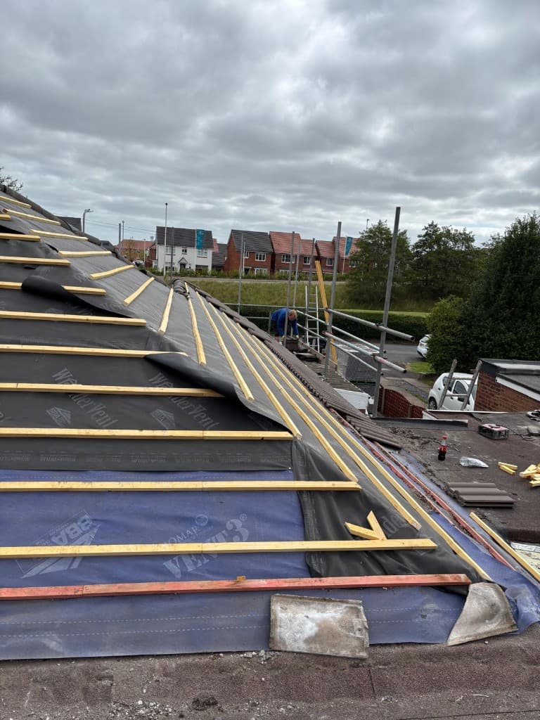 Gutter and fascia work on brick chimney elevation in Hyndburn by Holgates Roofing